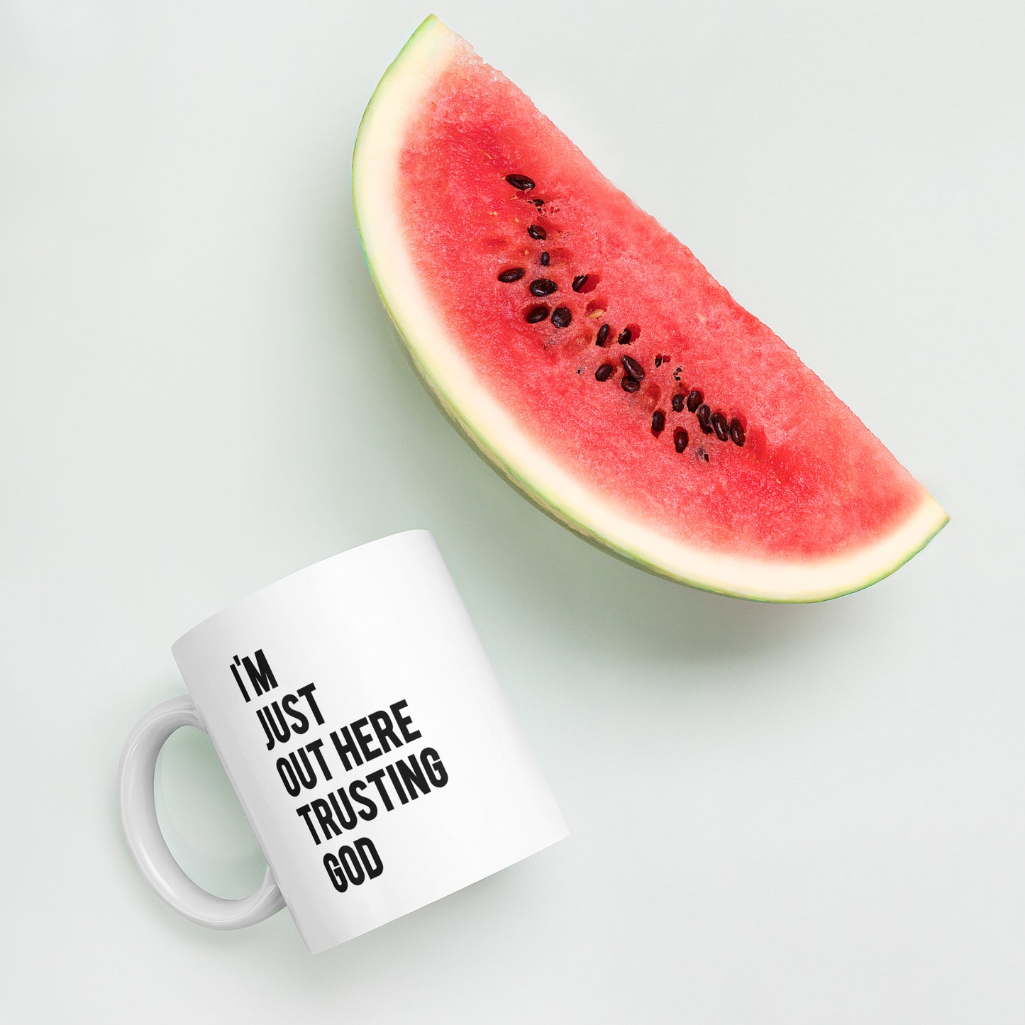 "I'm Just Out Here Trusting God" White glossy mug