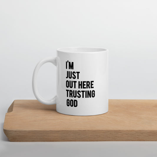 "I'm Just Out Here Trusting God" White glossy mug
